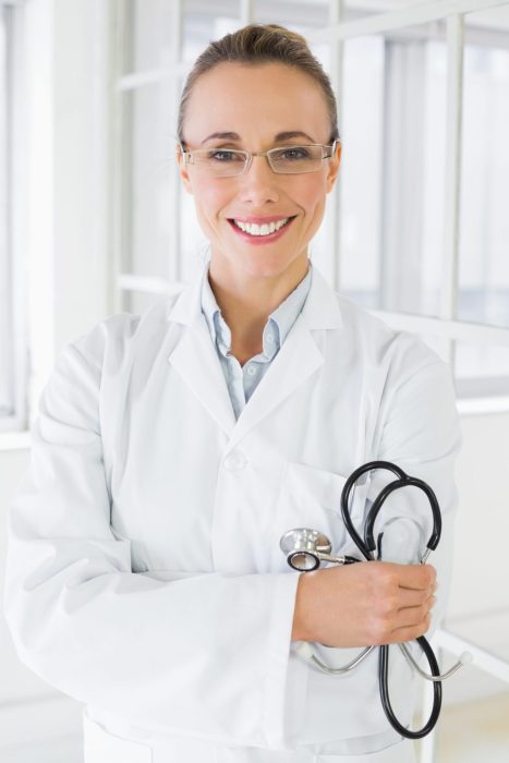 Portrait of a smiling female doctor with stethoscope in a bright hospital